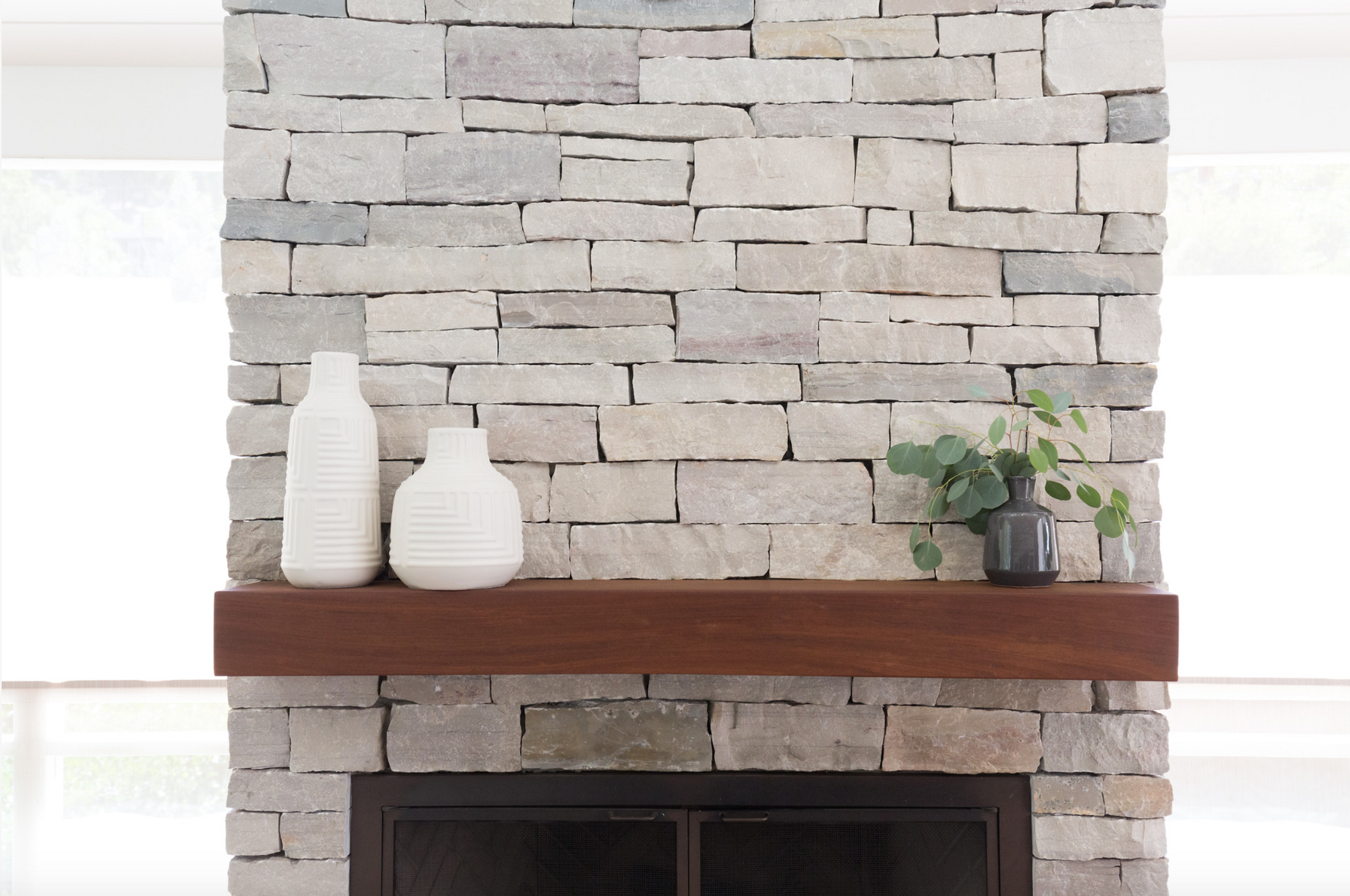 A stone fireplace adorned with a decorative vase, enhancing the elegance of the interior design