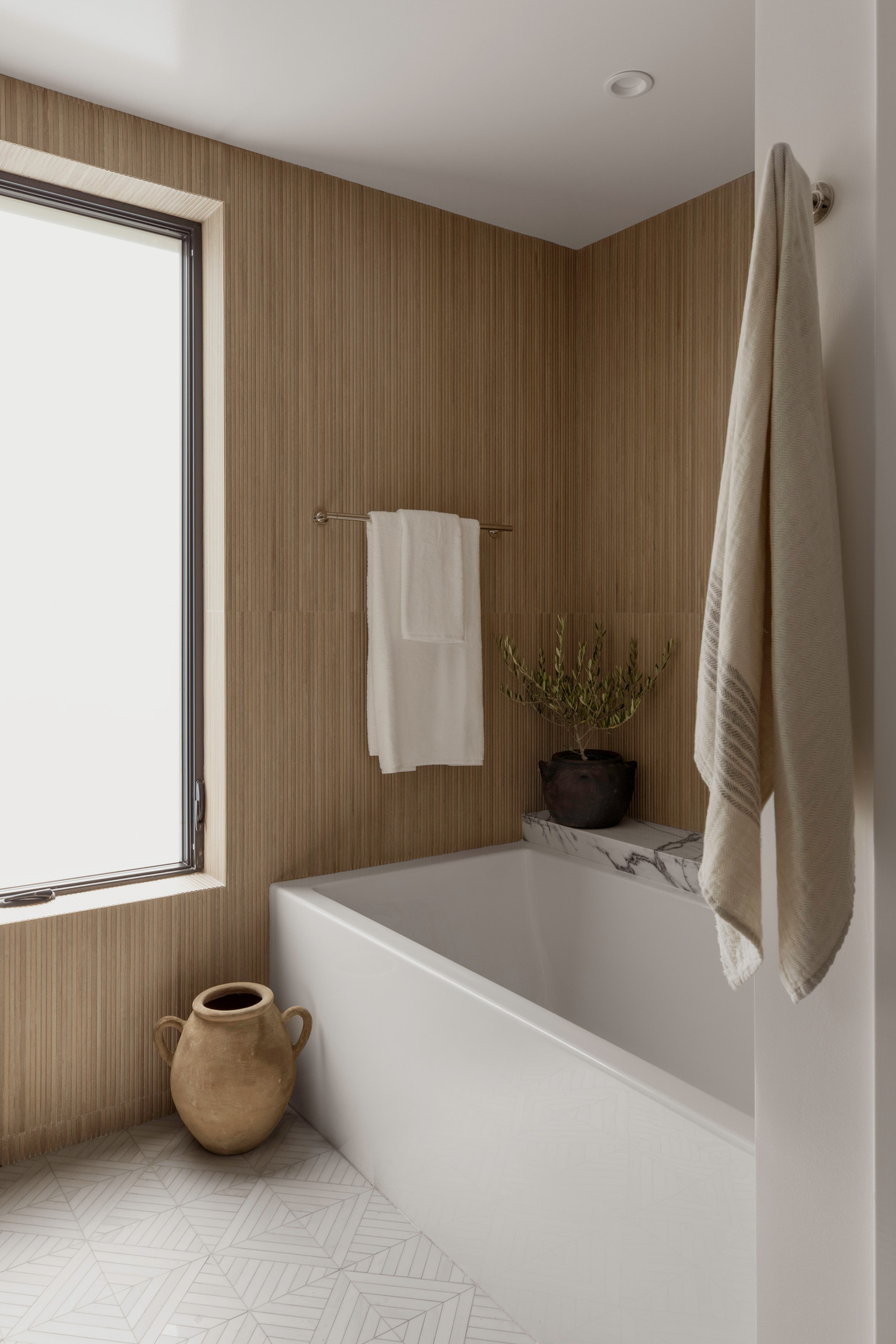 Bathroom decoration featuring bathtub, towel sets and water pitcher