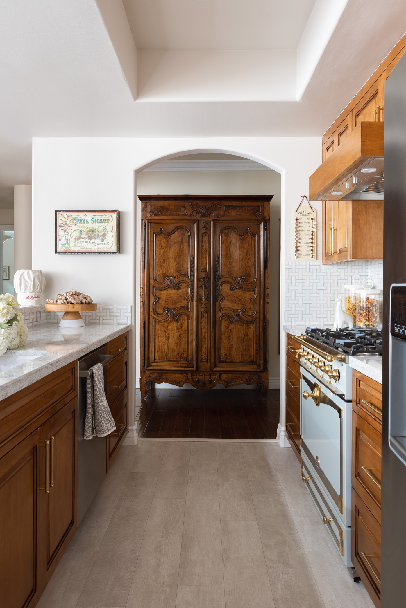 Kitchen interior design featuring a solid wooden door with gas oven and storage cabinets