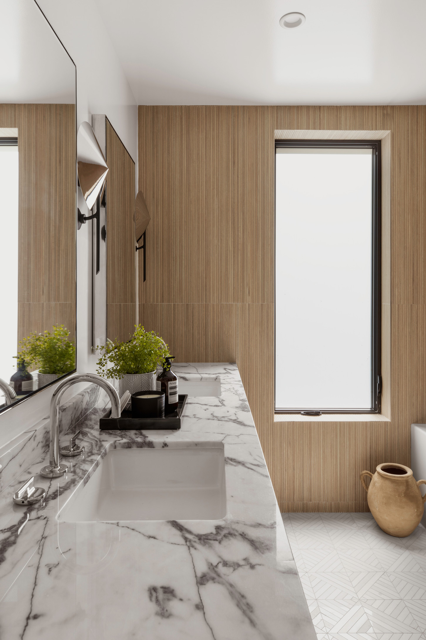 Casual bathroom decoration featuring marble sink with tap water filter, and water pitcher