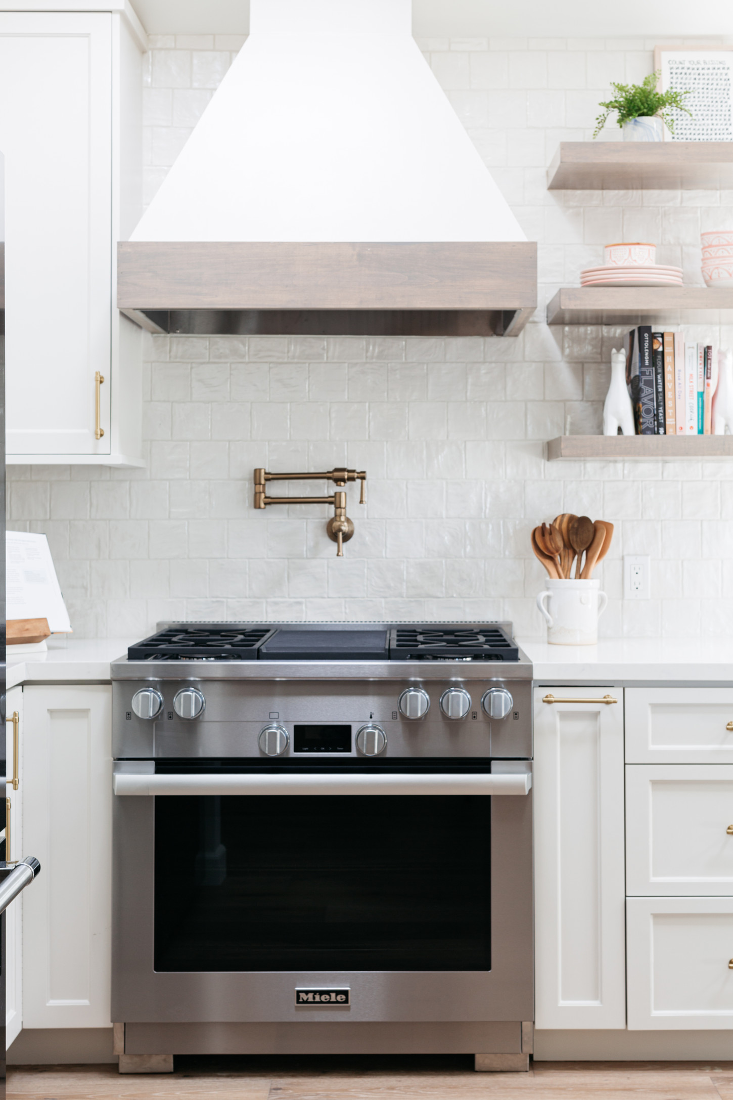 A modern kitchen featuring white cabinets and a sleek stainless steel oven